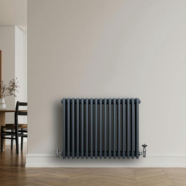 Traditional anthracite grey 4 column radiator with sleek vertical lines, mounted on a light wall, enhancing modern interior decor