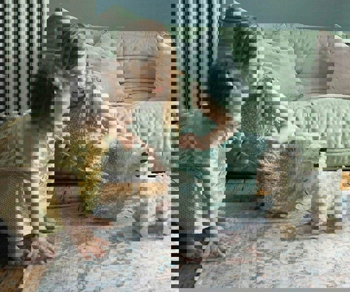 toddler girls playing with sheep teddy 