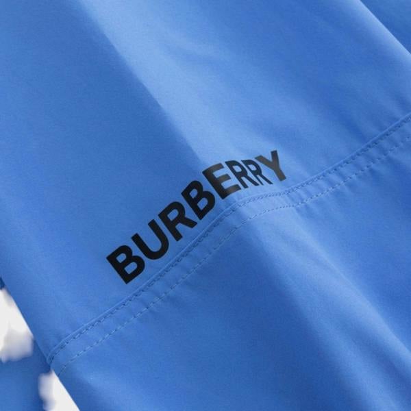 Supplied Fashion Burberry Birley long blue jacket featuring a bold black logo print on smooth fabric