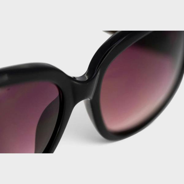 Supplied Fashion Linda Farrow oversized sunglasses featuring a black frame and gradient burgundy lenses.