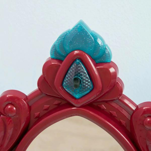 Close-up of red and blue princess mirror crown with teal glass and keyhole detail