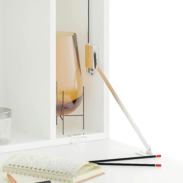 White drop-leaf desk hinge and support rod with cabinet opening and countertop