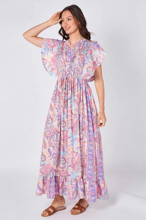 Woman wearing a colorful patterned dress on a white background