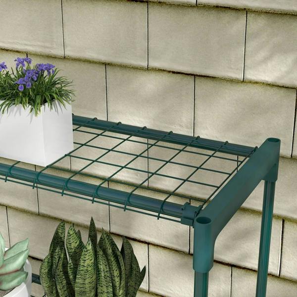 Angled view of green four-tier plant shelf with wire-grid top shelf and end caps.