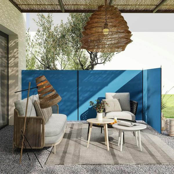 Blue outdoor privacy windbreak panels with steel poles on a patio seating area