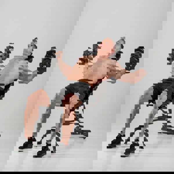 Man performing chest flyes on a HXGN Ultimate Dumbbell Weight Bench 