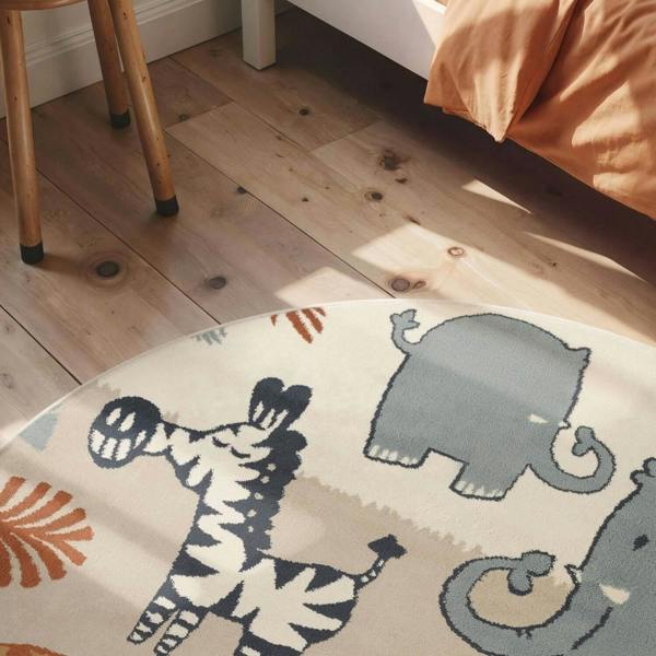 Children's rug with animal designs on a wooden floor