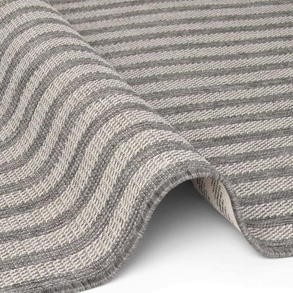 Close-up of a gray and beige striped fabric with a wavy pattern.