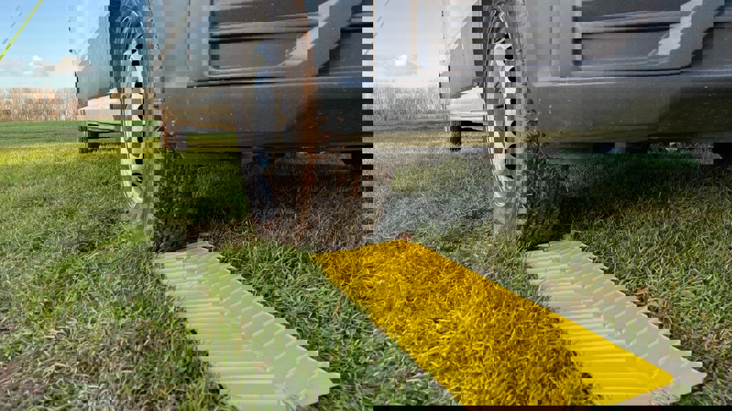 A closer image of the OLPRO Anti Slip Grip Mat being used in a grassy field with VW Crafter van.