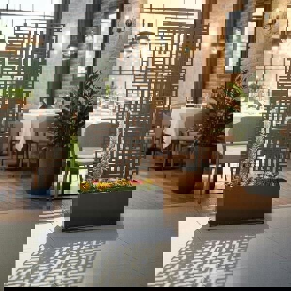 Grey privacy screen with geometric pattern in a modern dining area