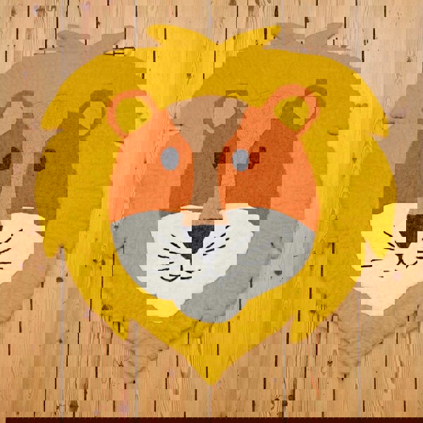 A handmade lion head rug on a wooden floor.