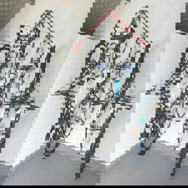 vertical bike storage rack showing 2 GearRails and 5 bike storage hooks mounted in an inverted v shape with 2 mountain bikes and 3 road bikes