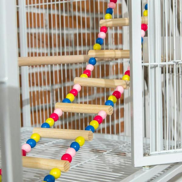 Colorful beaded rope ladder toy inside a white wire bird cage