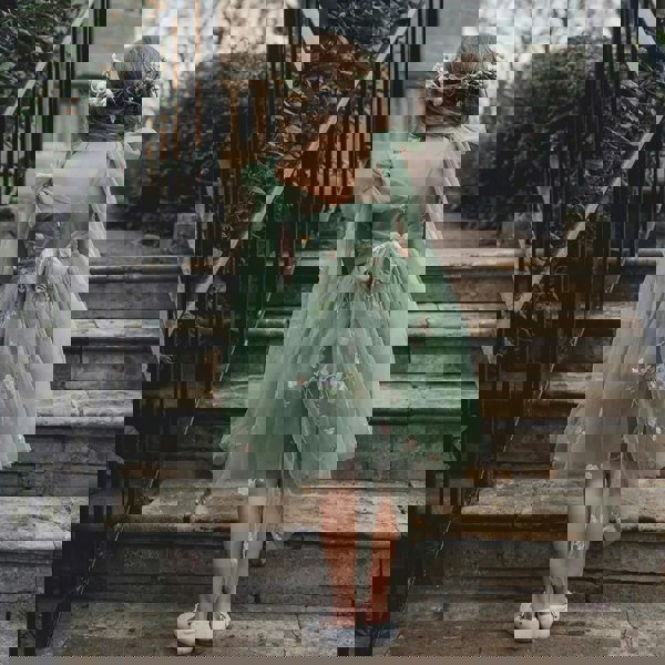 flower girl walking up steps