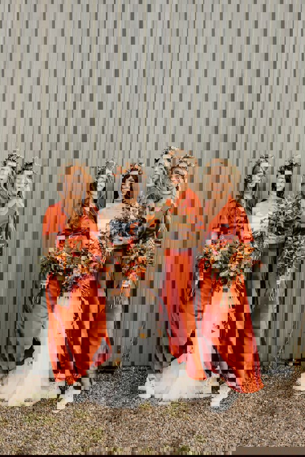 Satin wrap bridesmaids dress in burnt orange with a short sleeve A beautiful rich copper rust colour, this dress is a modern and stylish option for all occasions.