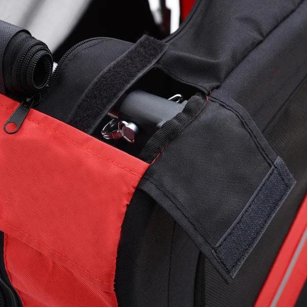 Red and black pet trailer door panel with metal latch and fabric straps