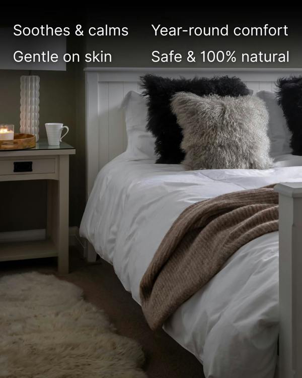 Black mongolian sheepskin pillow on bed with grey mongolian sheepskin pillow 