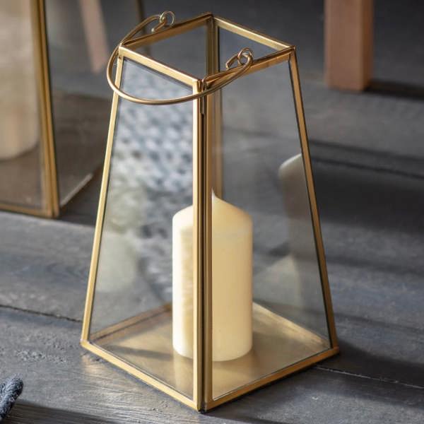 Small antique brass glass lantern with a white pillar candle.
