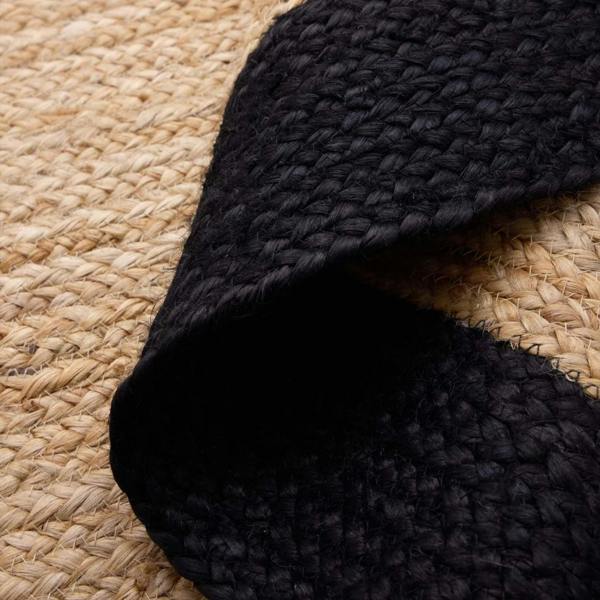 Close-up of black textured fabric on a woven beige surface