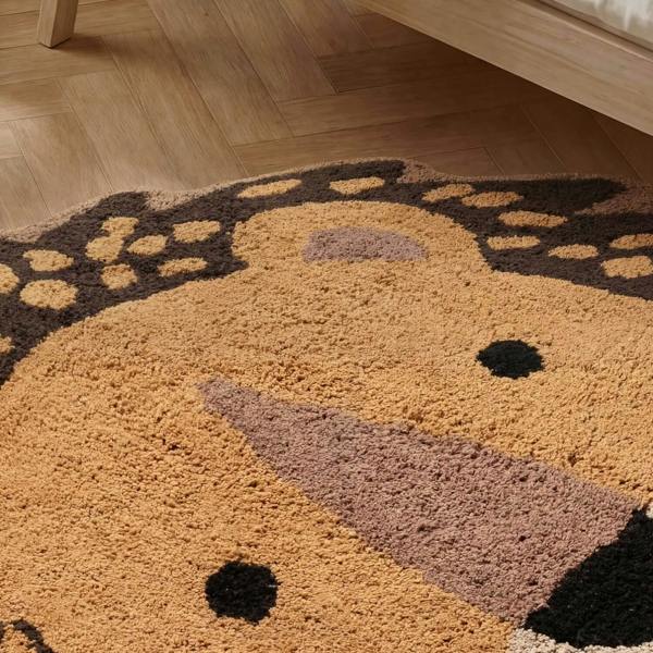 Round rug with a cartoon character design on a wooden floor