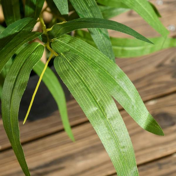 Close-up of artificial bamboo leaves in green tones
