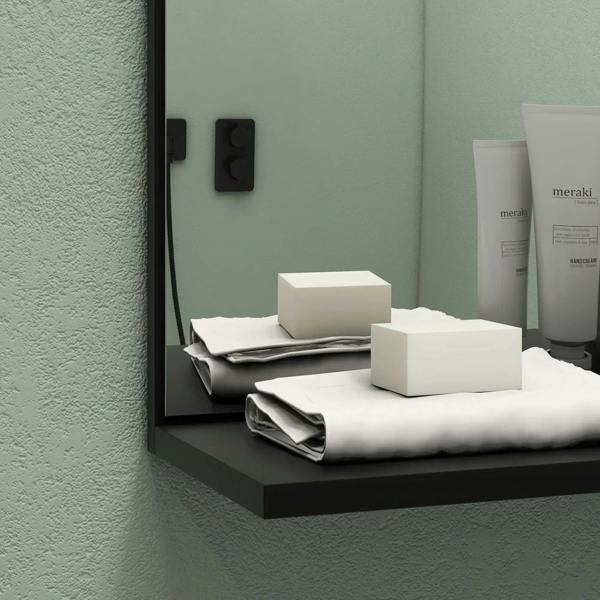 Black-framed bathroom mirror with bamboo side cabinet and black shelf ledge, supplies