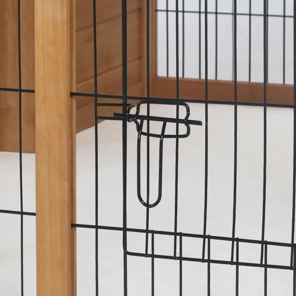 Black latch handle on wire mesh door inside a wooden rabbit hutch