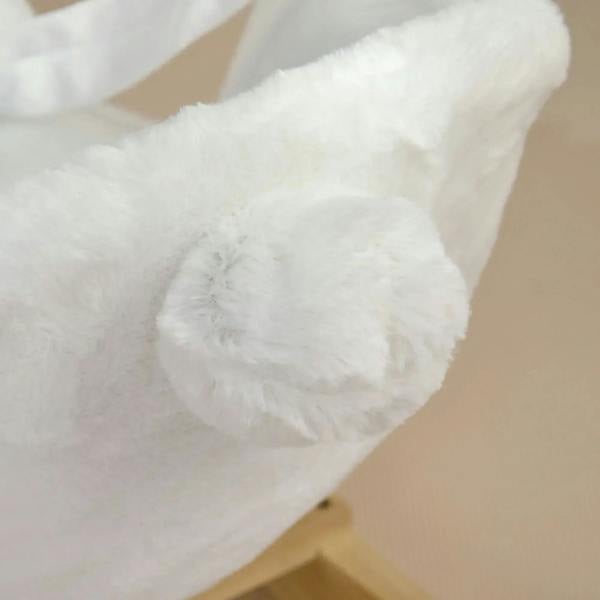 Close-up of the white plush rabbit ear on a rocking horse