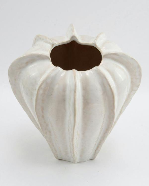 White ceramic vase with textured surface on a white background