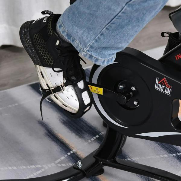 Close-up of black pedal with toe cage on the indoor stationary exercise bike