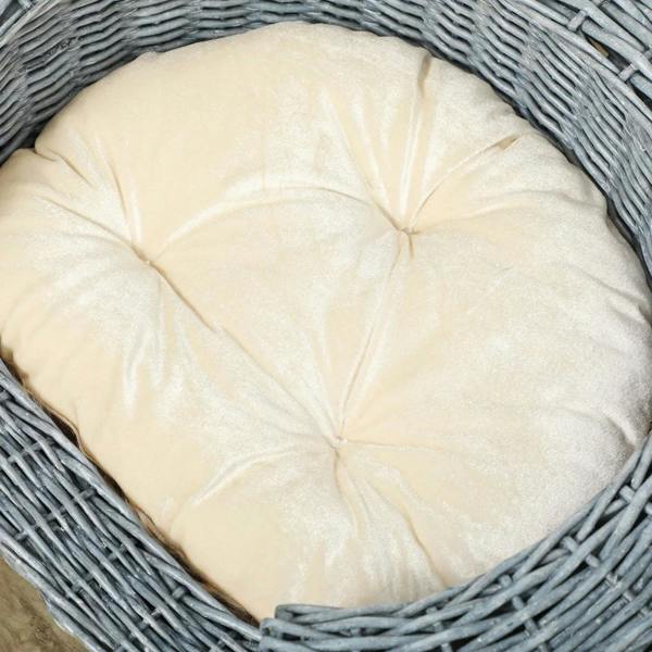 Grey wicker pet bed with beige tufted cushion insert
