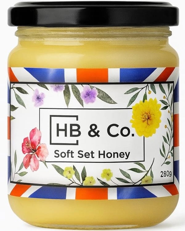 Jar of HoneyBee & Co. Soft Set Honey 280g with a creamy golden texture and floral Union Jack label design.