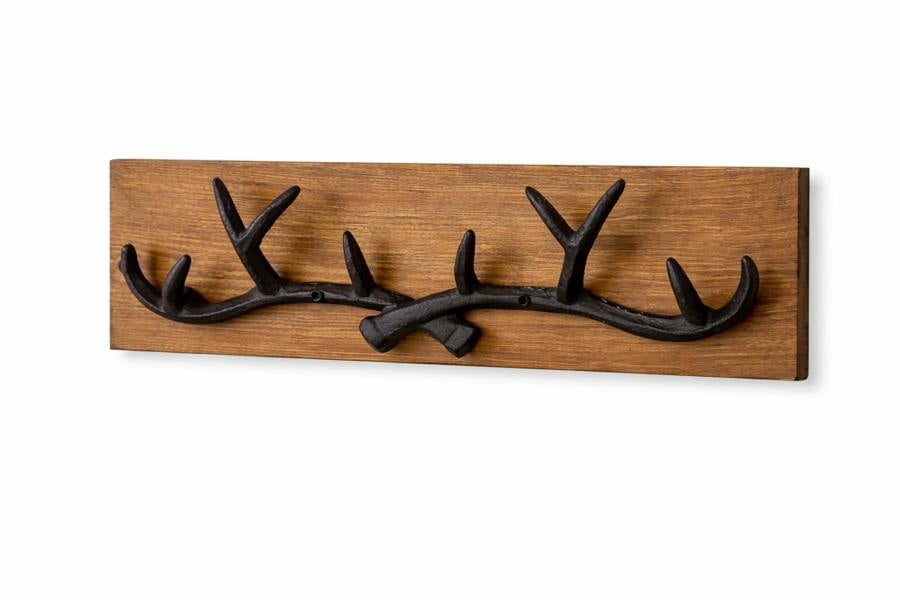 10 point cast iron antler coat hooks on pine board isolated on white background