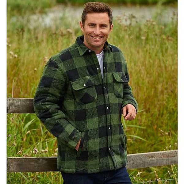 Farmer wearing green check Kinross shirt at gate for practical warmth and country style