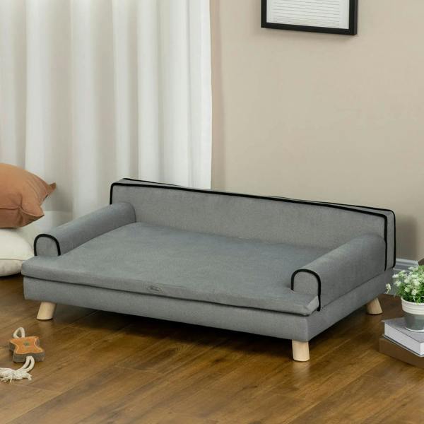 Grey dog sofa with black-trim armrests and raised cushioned base, wooden legs