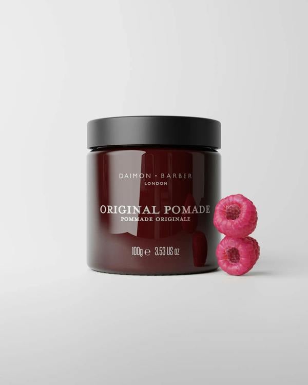 Jar of Original Pomade 100g with raspberries on grey background