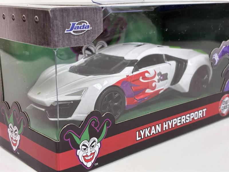 a white toy car in a box