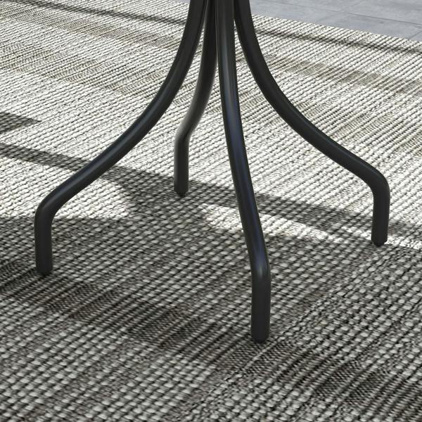 Close-up of dark grey curved metal legs on a round slatted garden table