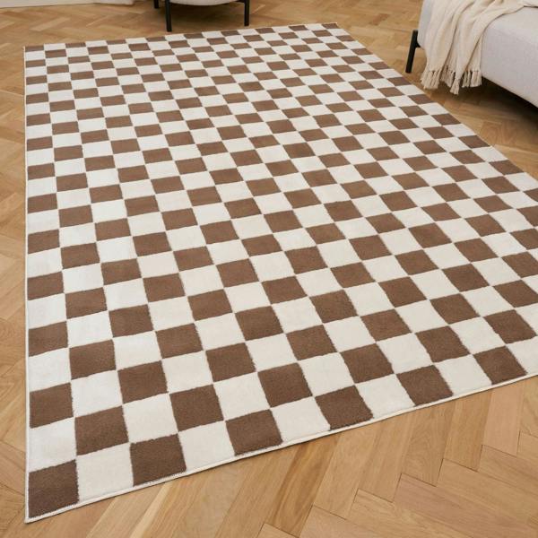 Checkered brown and white rug on a wooden floor