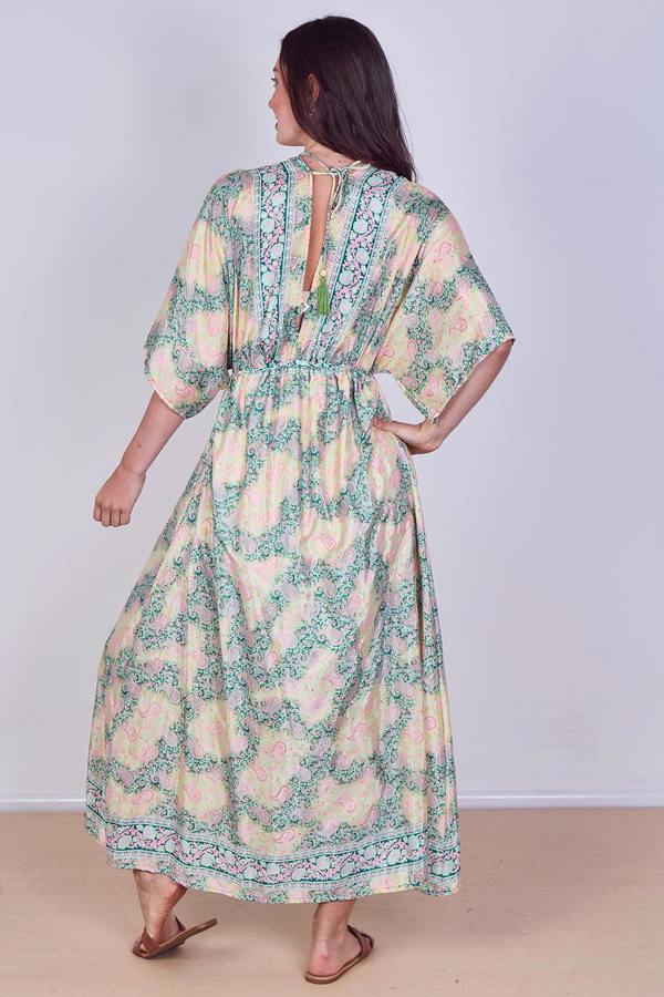 Woman wearing a floral dress with a plain background