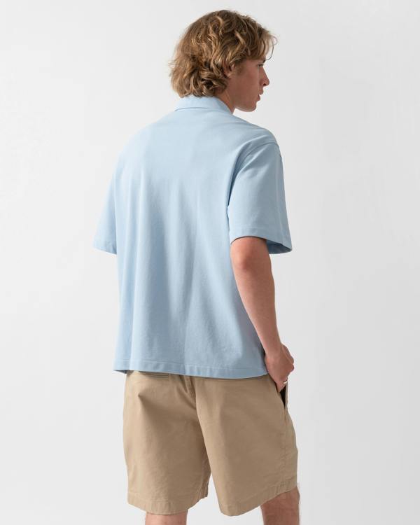 back of a model wearing a Lacoste Relaxed Fit Short Sleeved Mens Piqué Shirt in Chambray HBA