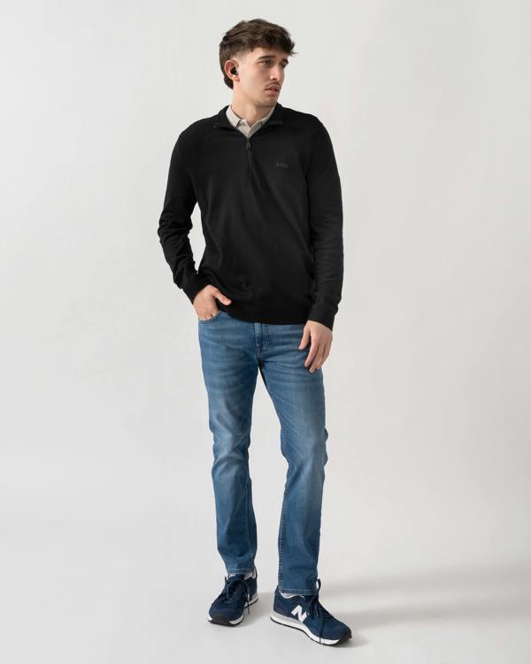 full length shot of a model wearing a BOSS Green Momentum-Lite Mens quarter Zip Funnel Neck Jumper in Black 001