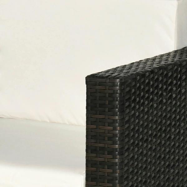 Rattan armrest corner close-up with dark brown woven frame and white cushion
