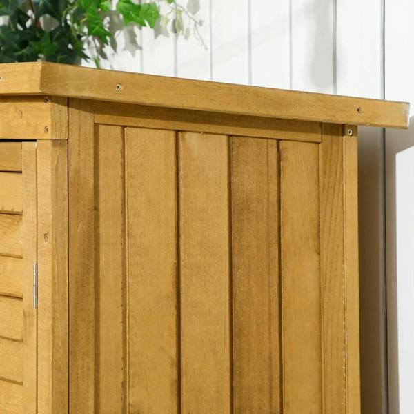 Close-up of wooden storage shed door panels with hinges, light wood