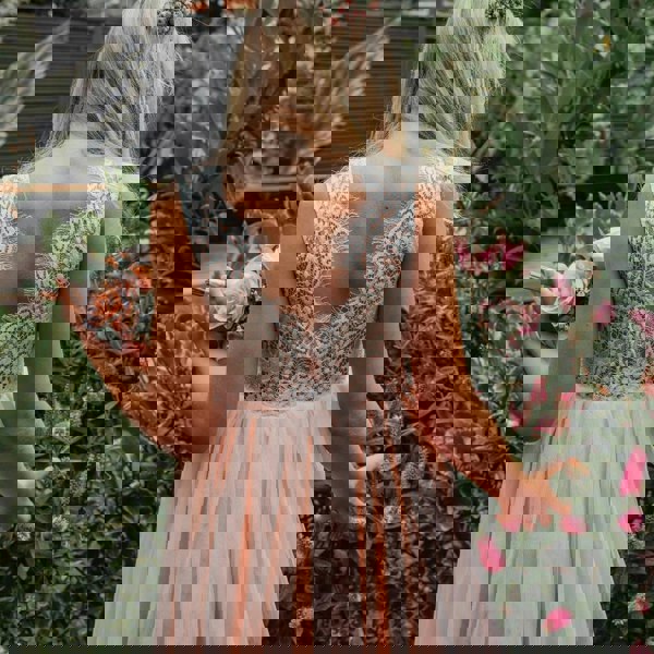 young flower girl in garden close up back of dress