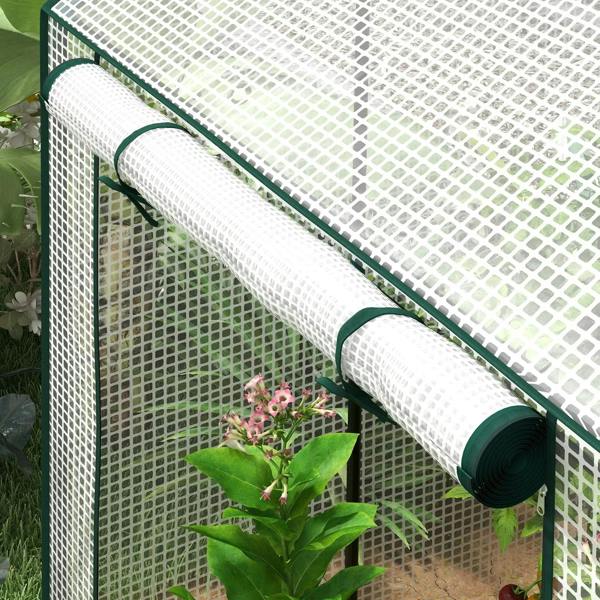Rolled white roll-up door on dark green rail for mini greenhouse