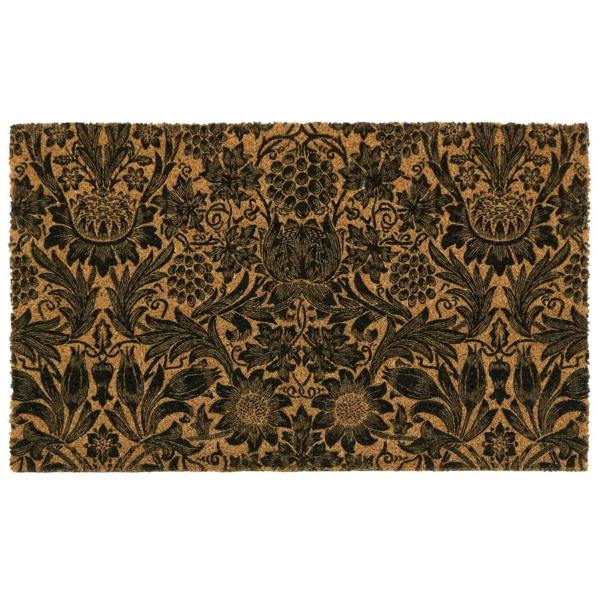 Floral patterned doormat with black design on a beige background