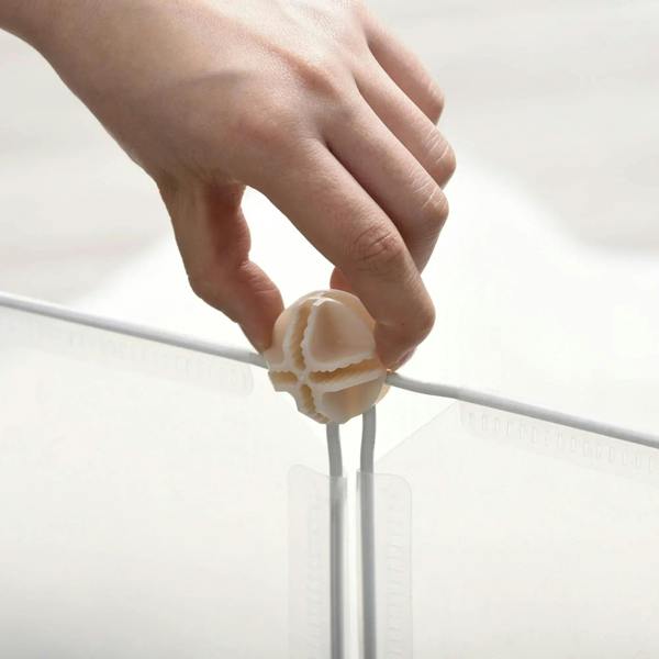 White plastic pet playpen panel connector with a hand installing a secure joint