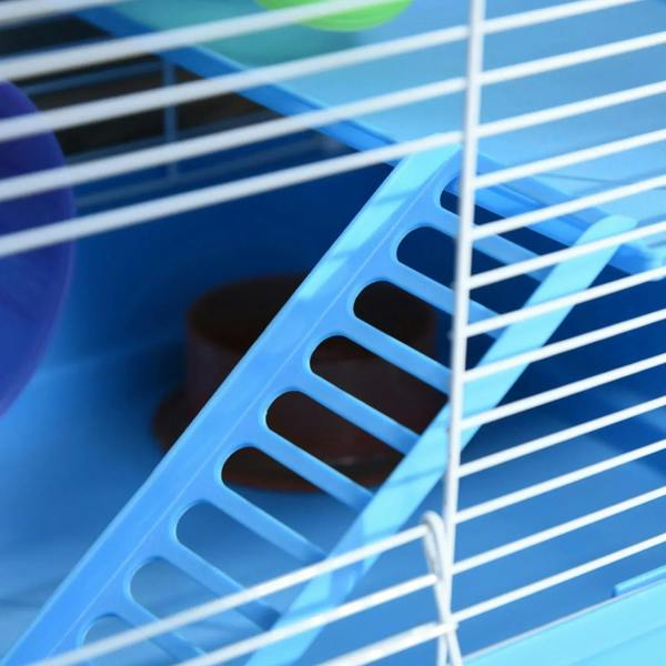 Close-up of blue wire cage side with plastic ramp and ventilation bars