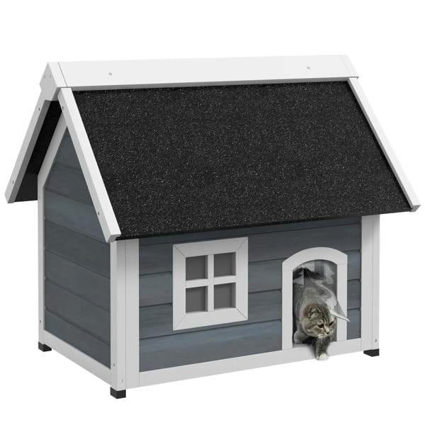 Grey wooden cat house with dark asphalt roof panel, front circular door, cat inside